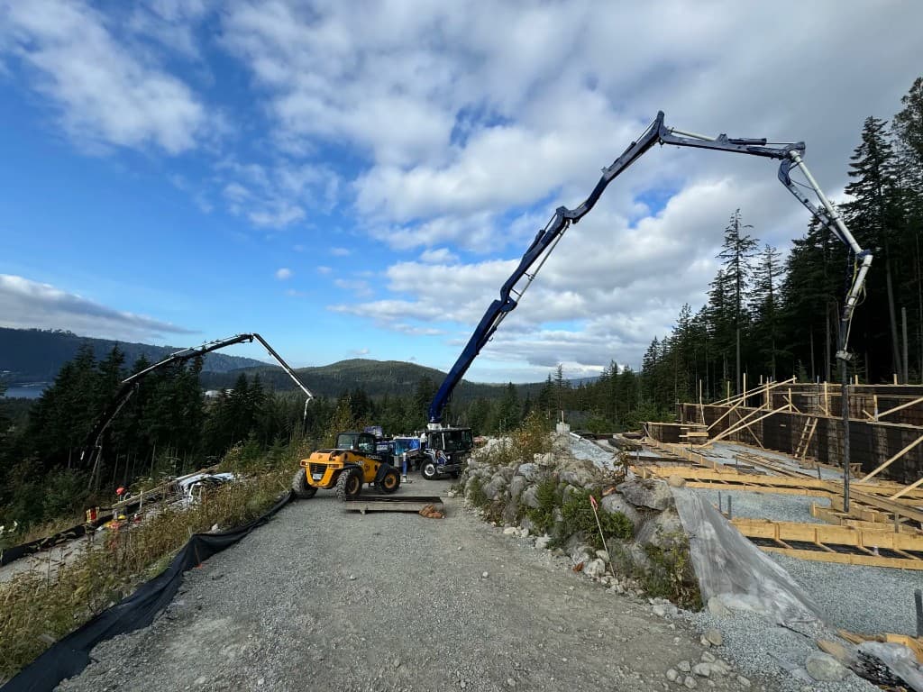Commercial foundation construction site with concrete pump trucks